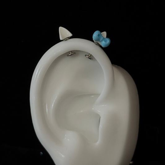 kitty ear style helix piercing with blue bow
