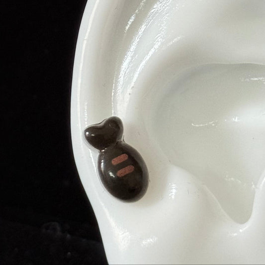 Glossy acrylic fish titanium piercing stud reflecting light — kawaii hypoallergenic earring from Meowverse cat jewelry collection